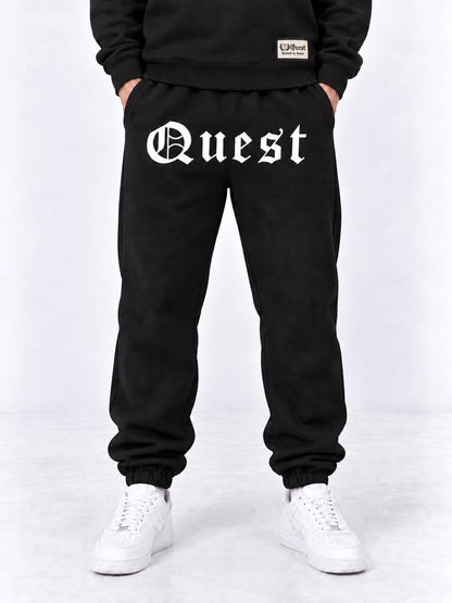 Black cuffed joggers with white blackletter Quest thigh print
