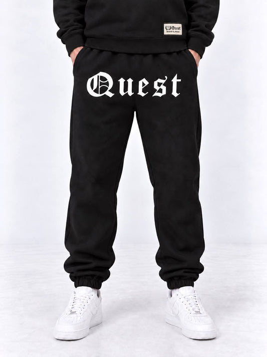 Black cuffed joggers with white blackletter Quest thigh print